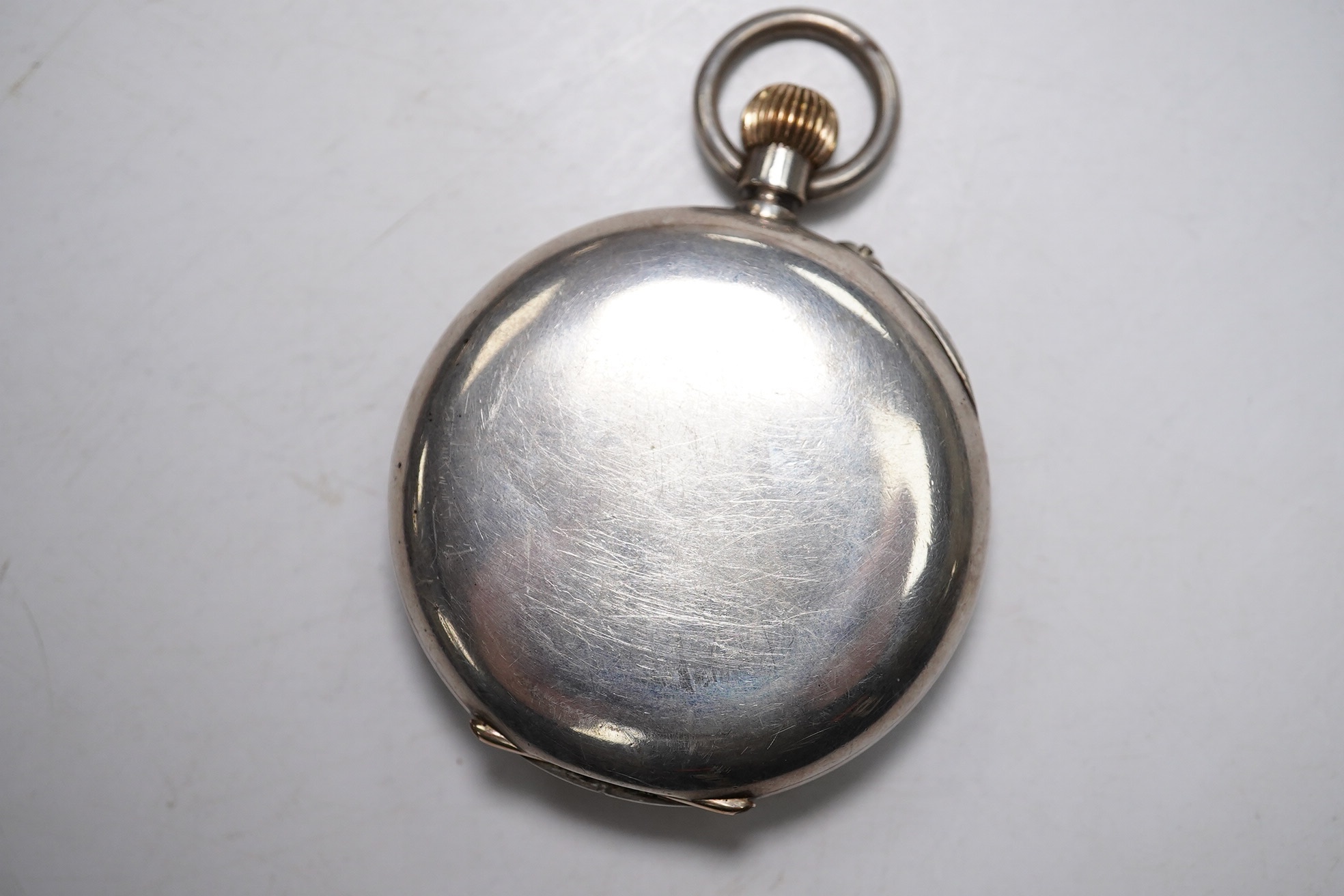 A Swiss 935 white metal half hunter pocket watch, in leather case. Condition - poor to fair